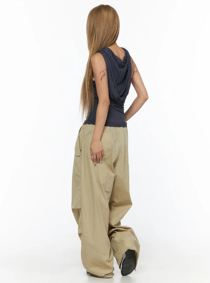 Shirred Sleeveless Hooded Crop Top CU524 Dark gray back-angle view on model showing draped hood detail and ruched back panel with cargo pants