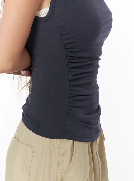 Shirred Sleeveless Hooded Crop Top CU524 Dark gray three-quarter front view on model with hood up hand adjusting hood showing full ruched body fit