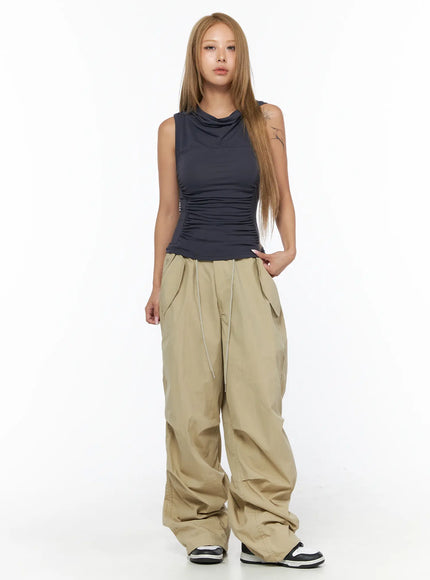 Shirred Sleeveless Hooded Crop Top CU524 Dark gray front full-body view on model without hood styled with wide-leg beige cargo pants and sneakers