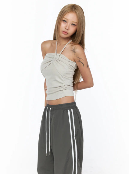 Shirred Strap Tube Top CU523 Light beige S/M three-quarter front model shot showing crossover shirred strap and gathered bust styled with bandana and sunglasses