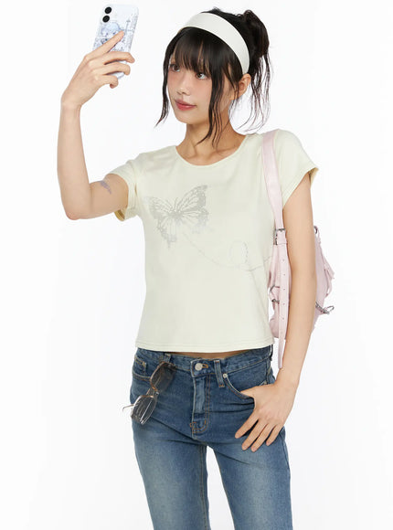 LEWKIN Short Sleeve Graphic Tee CU530 Light yellow front shot model selfie pose wearing pink backpack and blue jeans size S/M butterfly rhinestone print