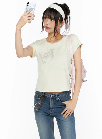 LEWKIN Short Sleeve Graphic Tee CU530 Light yellow front shot model selfie pose wearing pink backpack and blue jeans size S/M butterfly rhinestone print