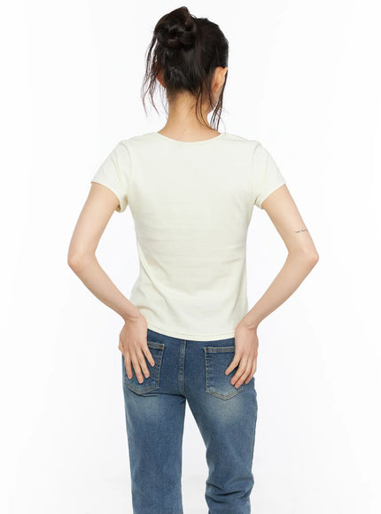 Short Sleeve Graphic Tee CU530 Light yellow back shot model standing showing plain clean back of cropped short sleeve tee with round neckline