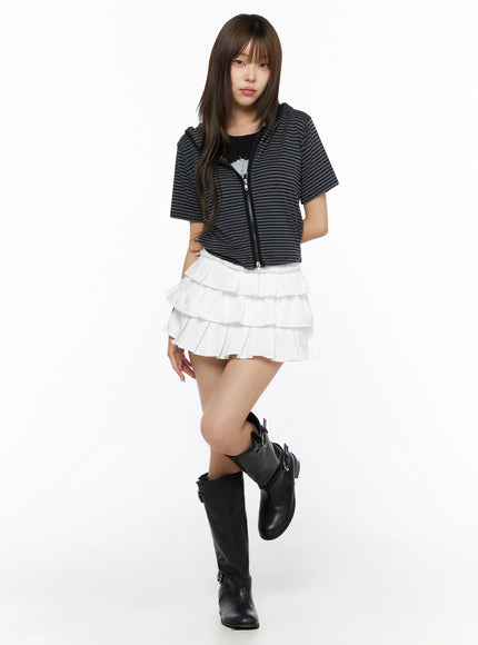Short Sleeve Hooded Jacket IL523 Black full-body front view on model with black knee-high boots, striped zip-up hooded crop top, paired with white layered ruffle mini skirt