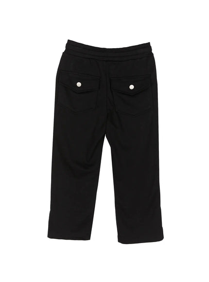 Side Slit Cropped Track Pants IL509 Black flat-lay back view showing dual snap-button flap pockets elasticated waistband and side slit cropped hem detail