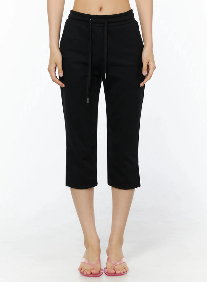 LEWKIN Side Slit Cropped Track Pants IL509 Black S/M front view on model cropped at waist showing drawstring waistband and straight leg hem with side slit