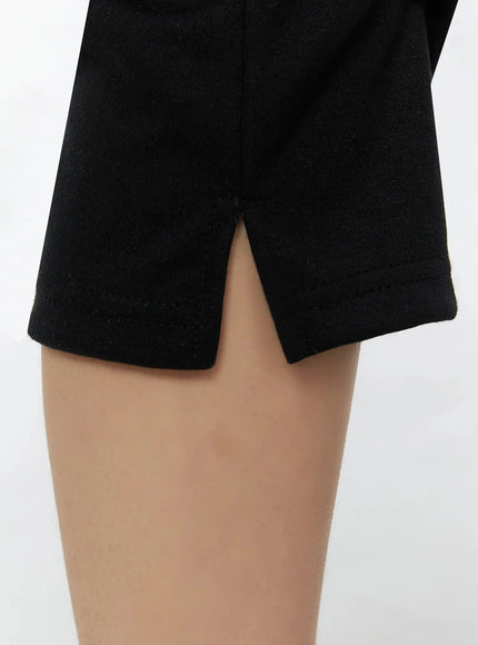 Side Slit Cropped Track Pants IL509 Black close-up detail of hem showing side slit opening and fleece fabric texture on model leg