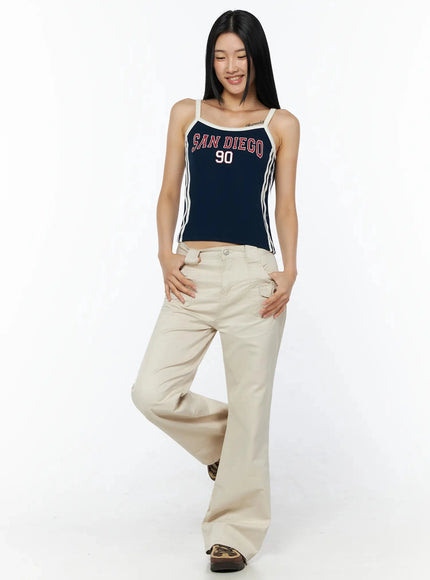Side Stripe Contrast Trim Cami Top IL516 Dark blue full-length front model shot smiling with one leg raised styled with cream wide-leg cargo pants
