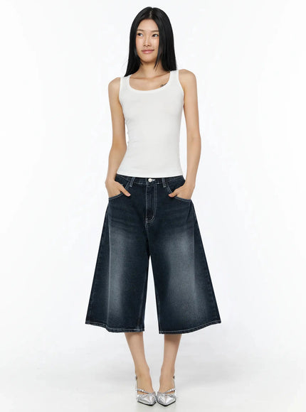 Silky Round Neck Tank Top IL509 White full-body front shot model hands in pockets looking away fitted silhouette with wide-leg dark denim culottes