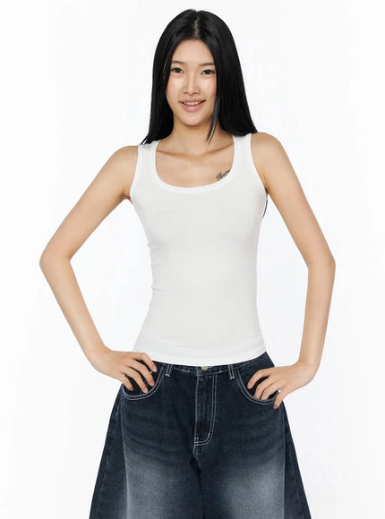 Silky Round Neck Tank Top IL509 White front shot smiling model hands on hips scoop neck fitted ribbed tank top styled with dark wash denim