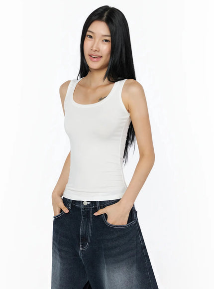 Silky Round Neck Tank Top IL509 White three-quarter front shot model smiling hands in pockets slight angle showing fitted silhouette and smooth fabric