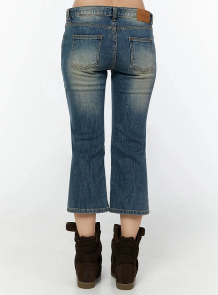 Simi Vintage Washed Capri Jeans IU524 Dark blue back waist-to-hip shot on model showing dual back pockets, amber topstitching, and ozbridge leather label close-up