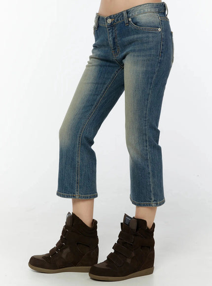 Simi Vintage Washed Capri Jeans IU524 Dark blue angled side view on model showing right side pocket detail, low-rise waist, and slight flare at cropped hem