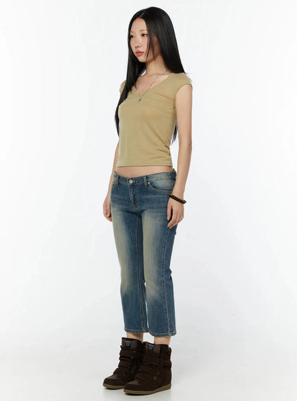 Simi Vintage Washed Capri Jeans IU524 Dark blue 3/4 angled side shot on model facing right, showing low-rise fit, faded wash, and slim flare leg