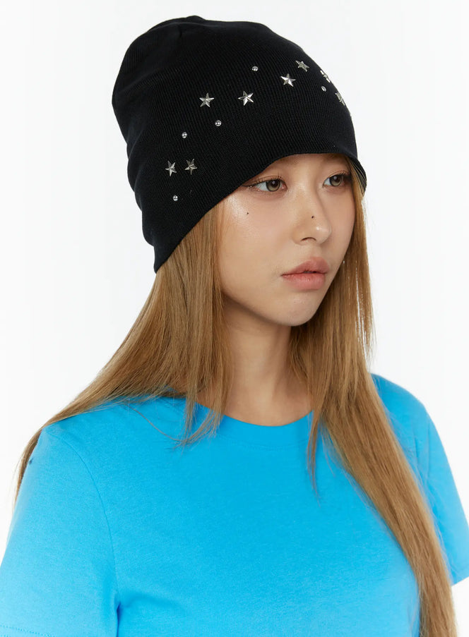 LEWKIN Simic Starmix Beanie IL503 Black three-quarter front view on model with long hair, silver star studs and rhinestone details on knit beanie