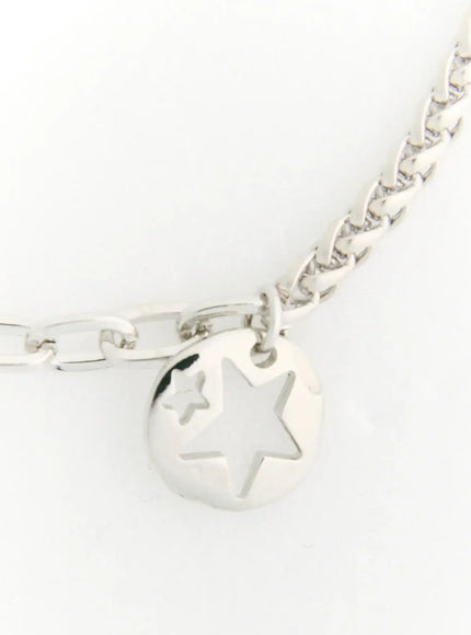 Skye Star Cut Bracelet IL522 silver close-up detail of round coin pendant with cut-out star design and mixed cable chain on white background