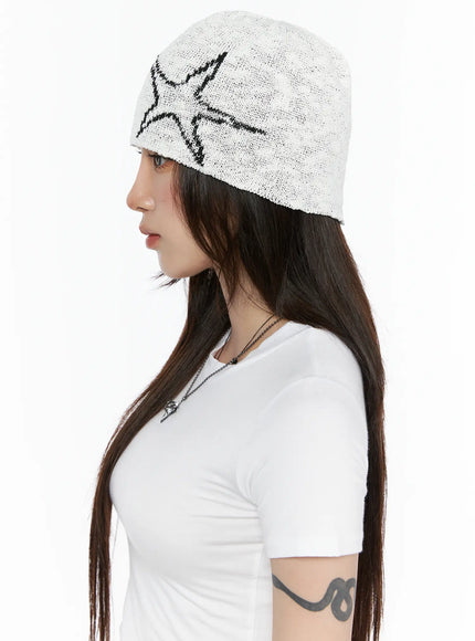 Slab Star Beanie IL503 White side profile view on model, loose open-knit texture with black star motif, paired with white fitted T-shirt