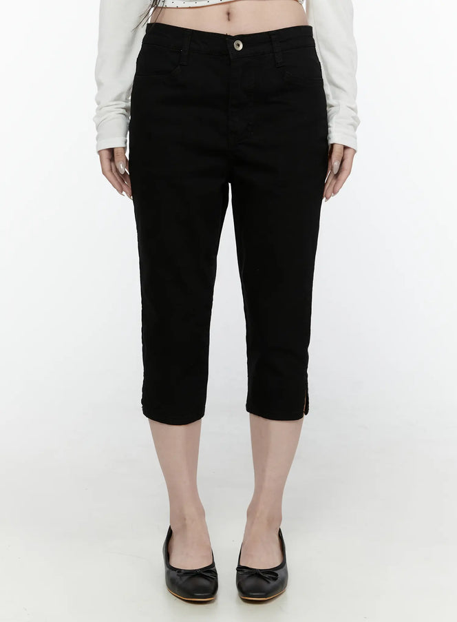 LEWKIN Slim Capri Pants IL521 Black Size S front view on model wearing white crop top and black ballet flats, cropped denim with button closure and hem slits