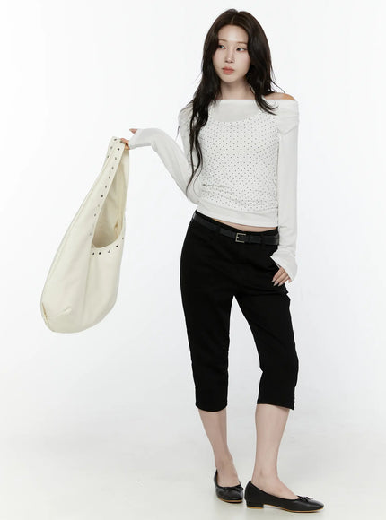 Slim Capri Pants IL521 Black three-quarter front view on model holding cream studded tote bag with black belt and ballet flats styling