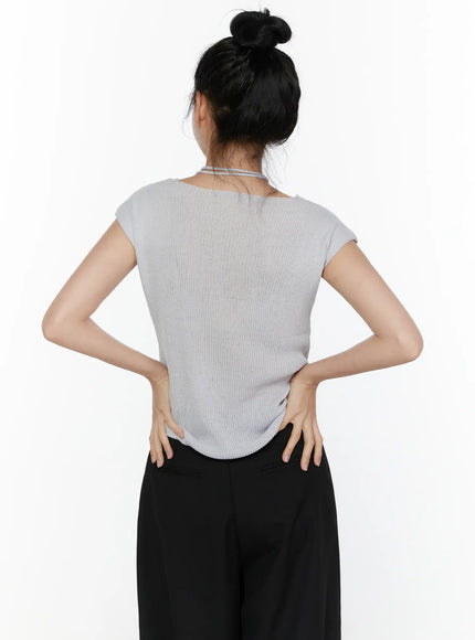 Slim Fit Boat Neck Knit Top CL520 Gray back shot on model with bun updo, revealing ribbed knit back panel, open neckline with string choker, cap sleeves, hands placed on lower back