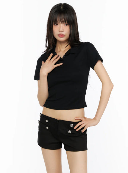 Slim Fit Collared Tee CU530 Black front shot on model standing hand on chest showing polo collar ribbed crop silhouette paired with black shorts