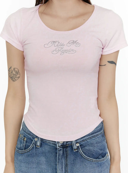 Slim Fit Graphic Tee CL508 Light pink close-up detail shot on model showing rhinestone Kiss Me Again lettering scoop neckline and body-skimming silhouette