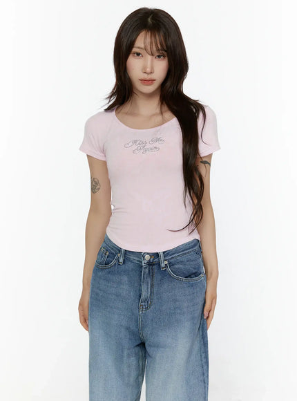 Slim Fit Graphic Tee CL508 Light pink front torso shot on model showing rhinestone Kiss Me Again script detail and scoop neckline with fitted ribbed stretch fabric