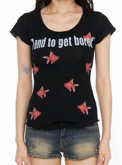 Slim Fit Graphic Tee CU530 Black close-up front shot on model showing 'Tend to get bored' text print, allover red goldfish graphic, scoop neck and lettuce-edge sleeves