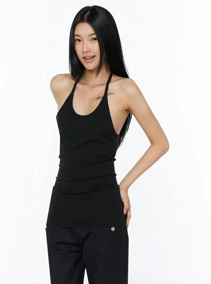 Slim Fit Halter Tank Top IL509 Black three-quarter front shot on model smiling hand on hip showing halter neckline and fitted ribbed body