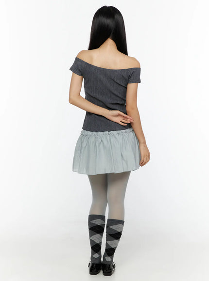 Slim Fit Off-Shoulder Tee CU526 Dark gray back model shot showing off-shoulder construction and ribbed knit back, argyle socks and loafers