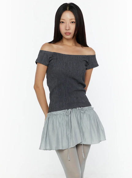 Slim Fit Off-Shoulder Tee CU526 Dark gray front model shot with hand in pocket, ribbed knit fitted silhouette and exposed shoulder detail