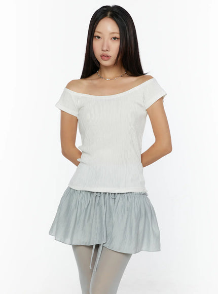Slim Fit Off-Shoulder Tee CU526 White front model shot standing with hands behind back, ribbed knit off-shoulder neckline, fitted silhouette