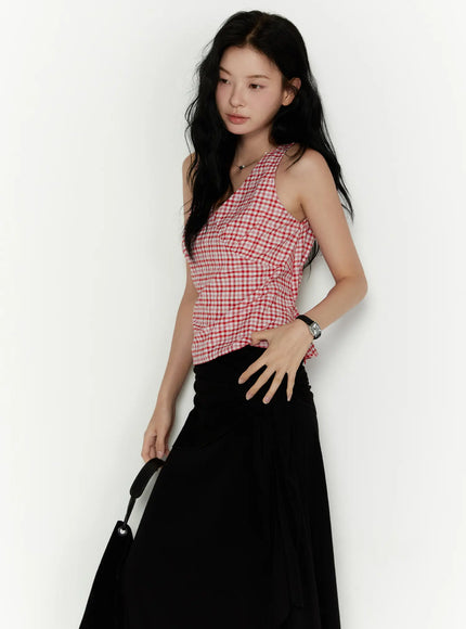 Slim Fit Plaid Sleeveless Top CL520 Red three-quarter front shot on model hand resting on hip holding black bag with black maxi skirt