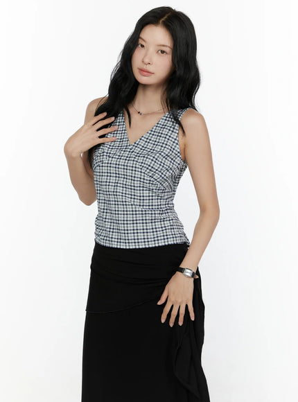 Slim Fit Plaid Sleeveless Top CL520 Navy/White front shot on model hand raised to chest showing V-neckline and bustier seam with black skirt