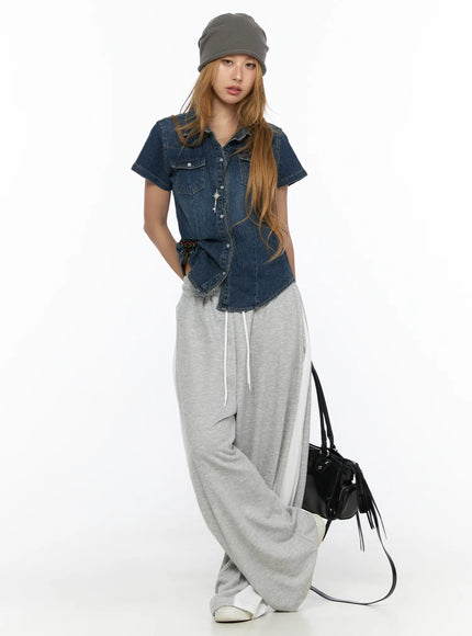 Slim Fit Wrinkle Wash Short Sleeve Jean Shirt CL528 Blue full-length front shot on model styled with grey wide-leg sweatpants grey beanie and black bag