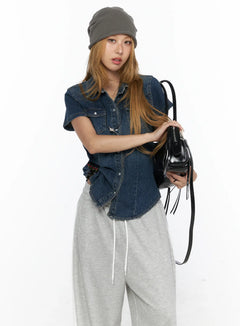 LEWKIN Slim Fit Wrinkle Wash Short Sleeve Jean Shirt CL528 Blue S front shot on model wearing grey beanie and grey sweatpants holding black bag