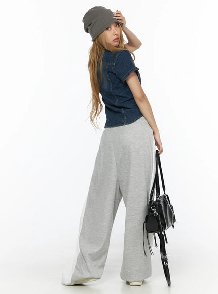 Slim Fit Wrinkle Wash Short Sleeve Jean Shirt CL528 Blue rear three-quarter shot on model with grey beanie looking over shoulder styled with grey wide-leg sweatpants