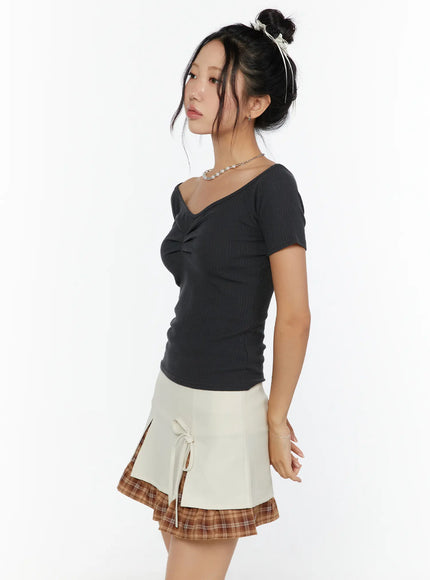 Slim Off-Shoulder Top CU526 Charcoal side view on model with bun updo, ribbed knit off-shoulder silhouette showing v-neckline ruching and fitted waist
