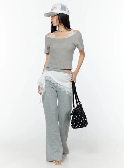 LEWKIN Slim U-Neck Short Sleeve Tee IU524 Gray S/M full-length front shot on model styled with lace-trim wide-leg pants, trucker cap, and polka-dot bag