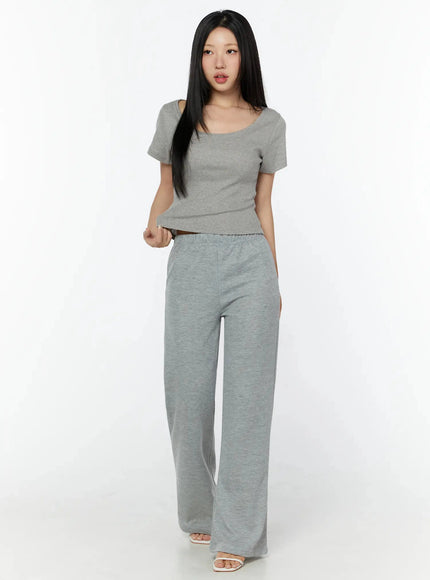 Slim U-Neck Short Sleeve Tee IU524 Gray full-length front shot on model in upright standing pose with one hand raised, showing fitted crop silhouette and flared pant hem