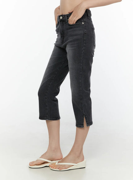 Slit Detail Capri Jeans CL521 washed black side view on model hand in pocket showing slim cropped silhouette and slit hem with flip-flops
