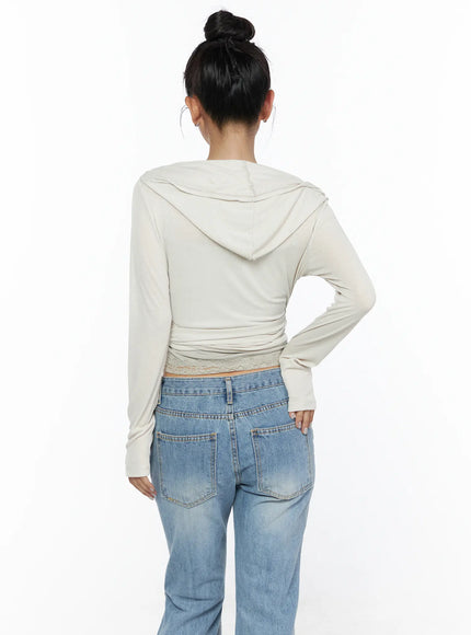 Soft Hooded Wrap Cardigan CL513 Beige back shot on model showing hood drape, gathered wrap straps at waist, lace trim hem, and soft ribbed knit fabric