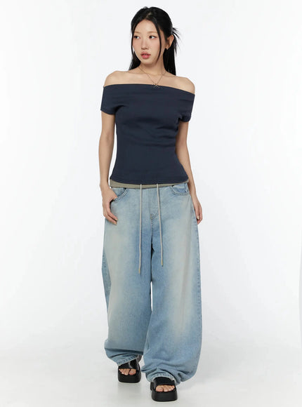 Solene Vintage Washed Foldover Baggy Jeans IU524 Blue full front shot on model standing upright styled with navy off-shoulder ribbed top and black platform sandals