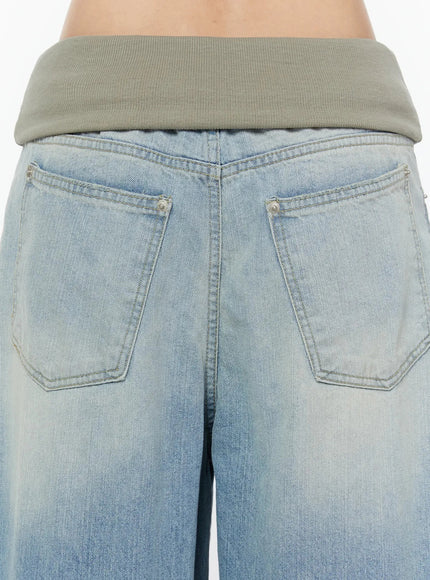 Solene Vintage Washed Foldover Baggy Jeans IU524 Blue close-up back detail of two pentagon-shaped back pockets with silver rivets and khaki ribbed foldover waistband