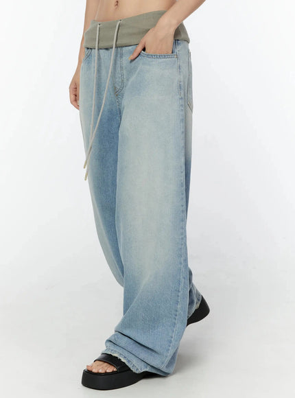 Solene Vintage Washed Foldover Baggy Jeans IU524 Blue side shot on model hand in pocket showing wide-leg silhouette foldover waistband and drawstring cord detail