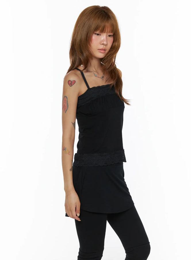 Square Neck Lace Cami CL503 Black side view on model, spaghetti straps with lace trim neckline and floral lace hem, styled with black skirt and leggings