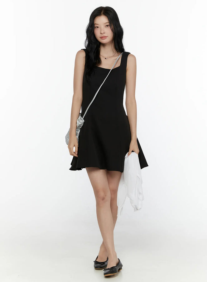 Square Neck Mini Dress CL521 Black full-body front shot on model wearing black bow ballet flats with silver bag and white jacket