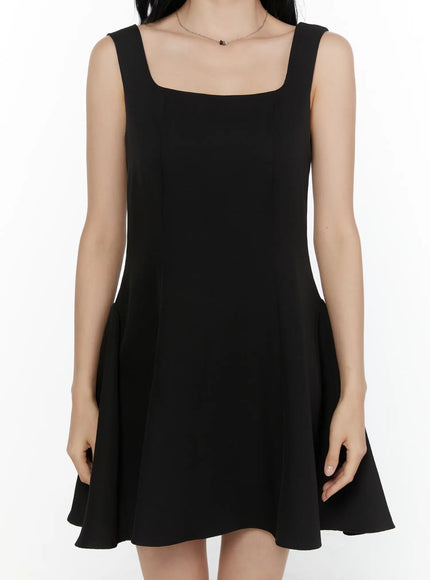 Square Neck Mini Dress CL521 Black front close-up detail shot on model highlighting square neckline, fitted bodice, and flared hem