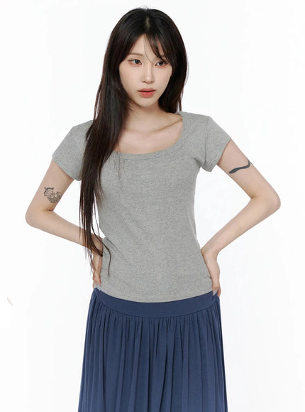 Square Neck Short Sleeve Tee IL502 Gray front shot on model hands on hips, slim ribbed knit fabric, square neckline, styled with navy pleated skirt