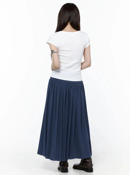 Square Neck Short Sleeve Tee IL502 White back shot on model arms crossed behind, showing clean back seam and fitted body-hugging cut, styled with navy pleated skirt